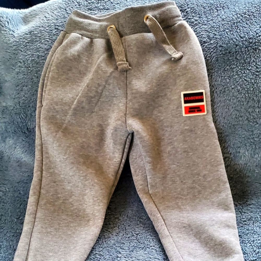 Gray boy sweatpants with sides and back pocket.  Drawstring waste.